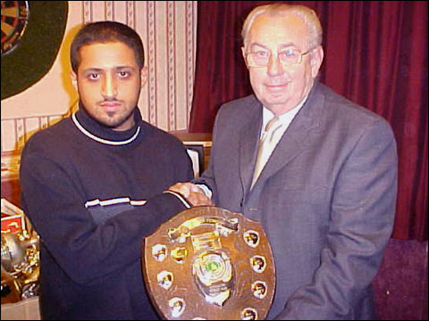 Mohsin Ahmed receives one of his trophies from Peter Barratt